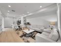 Open-concept living room and kitchen area with hardwood floors and recessed lighting at 4612 S Wenatchee St # A, Aurora, CO 80015