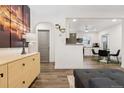 Open-concept living space featuring modern decor and seamless flow into the well-equipped kitchen and breakfast nook at 4463 Steele St, Denver, CO 80216