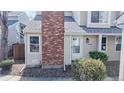 Close-up of a townhome entrance with a red brick chimney, offering a cozy and inviting curb appeal at 8300 W 87Th Dr # B, Arvada, CO 80005