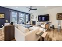 Bright living room featuring stylish furnishings, fireplace, and large windows at 1063 Sandstone Cir, Erie, CO 80516