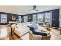 Spacious living room with hardwood floors, modern decor, and ample natural light at 1063 Sandstone Cir, Erie, CO 80516