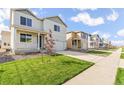 Neighborhood street view showing the home's facade, landscaped lawn, and a well-kept sidewalk at 3347 Belleville Ridge Rd, Elizabeth, CO 80107
