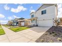 Street shot showing the house, driveway, and some landscaping with grass and gravel at 3347 Belleville Ridge Rd, Elizabeth, CO 80107