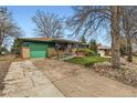 Ranch home featuring an attached garage, a ramp, and mature trees on a well-kept lawn at 13621 E Center Ave, Aurora, CO 80012