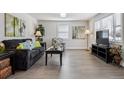 Cozy living room with modern furnishings, hardwood floors, and natural light from the windows at 20 S Harlan St, Lakewood, CO 80226