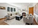 Bright living room with a fireplace, large windows, and comfortable seating area at 2535 Leyden St, Denver, CO 80207