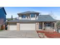 Charming two-story home boasts a brick and siding exterior, two-car garage, and manicured front yard at 1304 5Th St, Golden, CO 80403