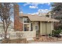 Charming two-story home with manicured front lawn, mature trees, brick chimney and inviting entrance at 2003 S Helena St # D, Aurora, CO 80013