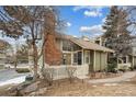 Charming two-story home with manicured front lawn, mature trees, brick chimney and inviting entrance at 2003 S Helena St # D, Aurora, CO 80013