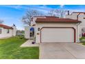 Home exterior featuring a tile roof, two-car garage and xeriscaped front yard at 1236 Sequerra St, Broomfield, CO 80020
