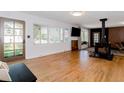 Spacious living room featuring hardwood floors, a fireplace, and plenty of natural light from large windows at 7684 Beverly Blvd, Castle Pines, CO 80108