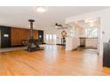Open living room boasts wood floors, a fireplace, and access to the balcony and kitchen at 7684 Beverly Blvd, Castle Pines, CO 80108