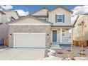 Attractive home with stone accents, a two-car garage, and a covered front porch, offering curb appeal at 13432 E 110Th Way, Commerce City, CO 80022