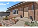 Welcoming front porch with modern planters, updated lighting, and a contemporary door at 3901 Newland St, Wheat Ridge, CO 80033