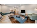 Spacious living room featuring a sofa, accent chairs, a modern coffee table and plenty of natural light at 8299 E Kenyon Ave, Denver, CO 80237