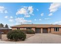 Brick ranch home with a 2-car garage and neat landscaping at 8661 W 32Nd Pl, Wheat Ridge, CO 80033