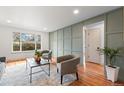 Bright living room with hardwood floors, modern furniture, and views of the outdoors at 8661 W 32Nd Pl, Wheat Ridge, CO 80033
