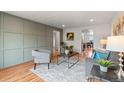 Inviting living room featuring a modern sofa, stylish decor, and hardwood floors at 8661 W 32Nd Pl, Wheat Ridge, CO 80033