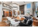 Spacious living room with a large dining table, custom shelving, and a climbing wall at 1610 Little Raven St # Ph6, Denver, CO 80202