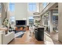 Open-concept living area with fireplace, large windows, and modern lighting fixtures at 1610 Little Raven St # Ph6, Denver, CO 80202