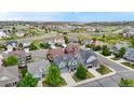 Community aerial view showcasing multiple homes, landscape, and beautiful neighborhood with rolling hills in the background at 3717 Desert Ridge Cir, Castle Rock, CO 80108