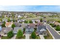 Community aerial view showcasing multiple homes, landscape, and beautiful neighborhood with rolling hills in the background at 3717 Desert Ridge Cir, Castle Rock, CO 80108