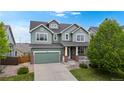 Charming two-story home boasts a well-manicured lawn, inviting curb appeal, and an attached two-car garage at 3717 Desert Ridge Cir, Castle Rock, CO 80108