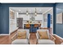 Open-concept kitchen with stainless steel appliances, large island, and stylish pendant lighting at 3438 Cade Ct, Castle Rock, CO 80104