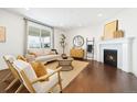 Cozy living room featuring a fireplace, modern furnishings, and bright natural light at 3438 Cade Ct, Castle Rock, CO 80104