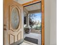 View of the beautiful front door with glass detailing and welcoming front porch at 205 Beech St, Hudson, CO 80642