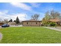 Spacious backyard with lush green grass and a well-maintained lawn at 6839 E 21St Ave, Denver, CO 80207