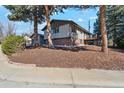 Well-kept home featuring a deck and mature trees, set on a spacious lot with groomed landscaping at 10121 W 70Th Dr, Arvada, CO 80004