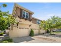Multi-level condo with garage parking, warm colors, and meticulous landscaping on a sunny day at 837 E 98Th Ave # 405, Thornton, CO 80229