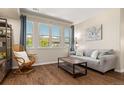 Cozy living room featuring natural light, hardwood floors, a comfortable sofa, and stylish decor at 837 E 98Th Ave # 405, Thornton, CO 80229