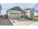 This home has a two-car garage, neutral color palette, rock accents, and well-kept landscaping at 754 Anderson St, Lochbuie, CO 80603