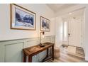 Inviting foyer with a console table, modern lighting, and a view of the front door at 1832 Marlowe Cir, Erie, CO 80516