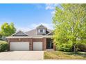 Beautiful brick two-story home featuring a two-car garage and well-manicured front yard at 1513 Cannon Mountain Dr, Longmont, CO 80503