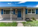 Inviting covered front porch with decorative columns and a vibrant blue front door at 7301 Dale Ct, Westminster, CO 80030