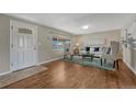 Bright living room with hardwood floors, a large window, and stylish furnishings at 7301 Dale Ct, Westminster, CO 80030