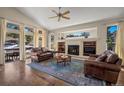 Bright living room with a fireplace, built-in shelving, and large windows at 20217 Kenneth Lainer Dr, Monument, CO 80132