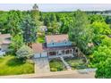Aerial view of lovely home surrounded by lush greenery and a well-manicured lawn at 6721 S Clayton Way, Centennial, CO 80122