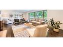 Bright living room features large windows, comfortable seating, and stylish decor at 3695 E Dartmouth Ave, Denver, CO 80210