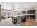 Spacious open-concept living room with a large sofa, hardwood floors, and kitchen access at 4073 S Liverpool St, Aurora, CO 80013