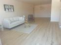 Spacious living room featuring light wood floors and a comfy seating area at 1120 Tucson St, Aurora, CO 80011