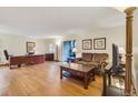 Comfortable living room with wood floors, a leather sofa, wood furniture and sliding door access to the outdoors at 13952 E Marina Dr # 102, Aurora, CO 80014