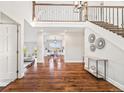 Elegant foyer with hardwood floors, staircase with iron railing, and views to living areas at 2357 Oak Ridge Rd, Sedalia, CO 80135