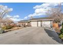 Home featuring a spacious driveway leading to a two-car garage at 3700 Miller St, Wheat Ridge, CO 80033