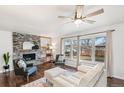 Cozy living room features a stone fireplace and large windows at 3700 Miller St, Wheat Ridge, CO 80033