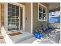 Inviting front porch with seating area, providing a cozy outdoor space at 4247 Thistlesage Ct, Castle Rock, CO 80109