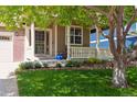 Charming home featuring a well-maintained front yard with landscaping and a covered front porch at 4247 Thistlesage Ct, Castle Rock, CO 80109